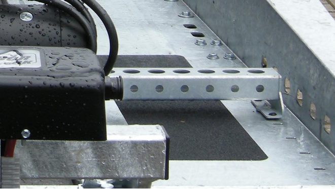 Wheel chocks, pair of individually adjustable position in front of bed area
